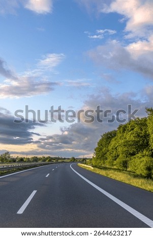 Sunset highway. Empty road. Communication tower