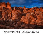 Sunset hour at Fiery Furnace, a collection of sandstone hoodoo formations within Arches National Park located near Moab in central Utah, United States.