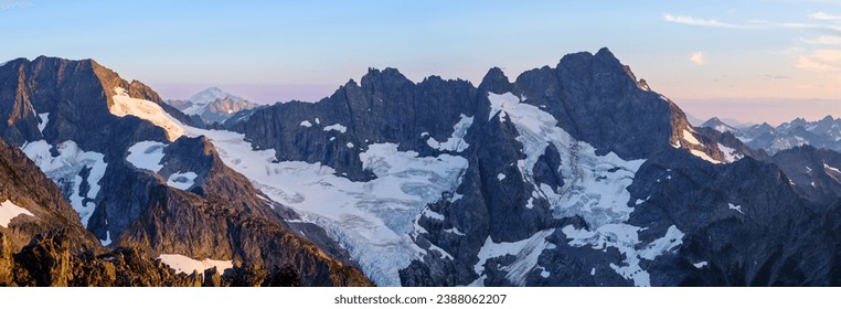 Sunset Illuminates A Panoramic View of Glaciers, Spider Mountain and Mount Formiddable. 
Ptarmigan Traverse, North Cascades National Park, Washington.