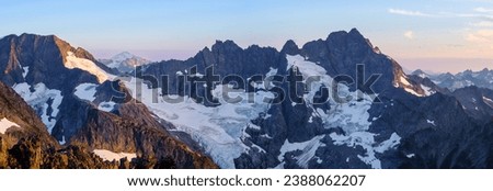 Sunset Illuminates A Panoramic View of Glaciers, Spider Mountain and Mount Formiddable. 
Ptarmigan Traverse, North Cascades National Park, Washington.