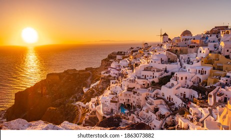 Sunset at the Island Of Santorini Greece, beautiful whitewashed village Oia with church and windmill during sunset, streets of Oia Santorini during summer vacation at the Greek Island - Shutterstock ID 1863073882