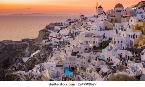 Sunset at the Island Of Santorini Greece, beautiful whitewashed village Oia with church and windmill during sunset, streets of Oia Santorini during summer vacation at the Greek Island - Shutterstock ID 2249908697