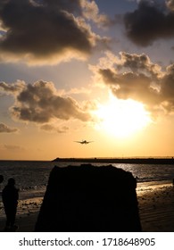 Sunset At Kelan Beach, Tuban, Bali, Indonesia With Silhoutte Of Airplane Landing To The Airport.