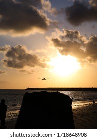 Sunset At Kelan Beach, Tuban, Bali, Indonesia With Silhoutte Of Airplane Landing To The Airport.