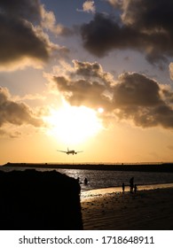 Sunset At Kelan Beach, Tuban, Bali, Indonesia With Silhoutte Of Airplane Landing To The Airport.