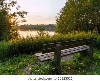 Sunset at the lake with a bench