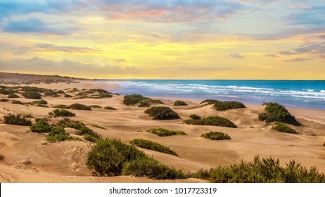 Sunset landscape in Agadir, Morocco, where desert sand turns into a beach at the Atlantic Ocean. - Powered by Shutterstock