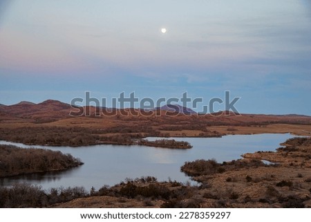 Sunset landscape with a full moon in Wichita Mountains National Wildlife Refuge at Oklahoma