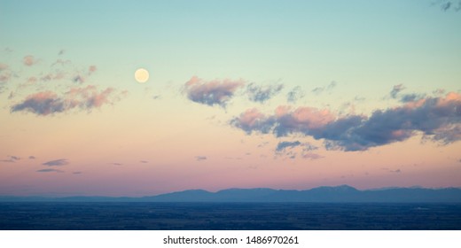 Sunset landscape pink sky and clouds   moon  beautiful fantasy pastel colorful landscape background  gradient sky  sunrise and mountains in distant