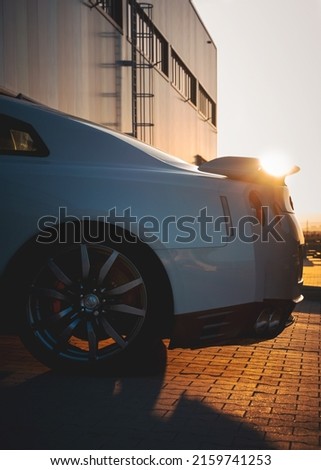 Sunset light casting onto parked sports car