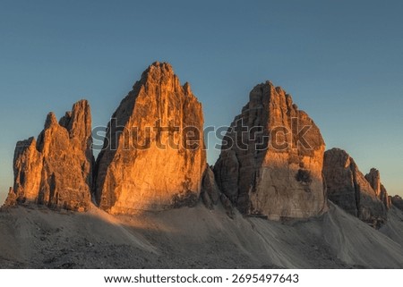 Sunset Light on Tre Cime di Lavaredo Peaks in Dolomites