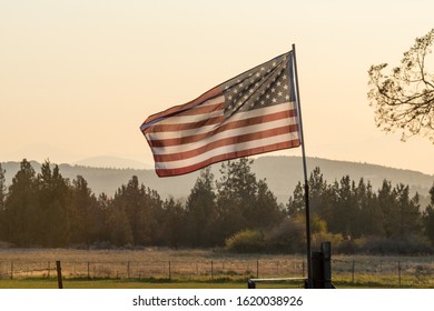 Sunset Light Passes Through A Waving U.S. Flag Near Terrebonne, Oregon, United States