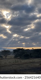 Sunset with light peeking through the clouds 

