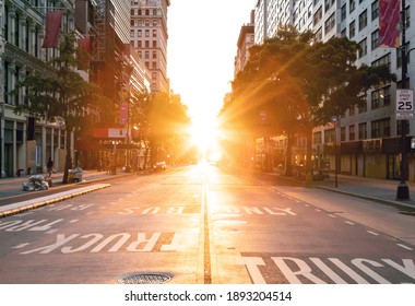 Sunset light shines over an empty view of 14th Street seen from Union Square Park in New York City NYC