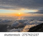 Sunset light spreading over dense clouds above the slopes of Babadag in Oludeniz. The image conveys the concept of open sky atmosphere and high natural space.