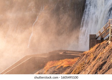 Sunset light through the mist at the bottom of the beautiful Montmorency Falls near Quebec City. 