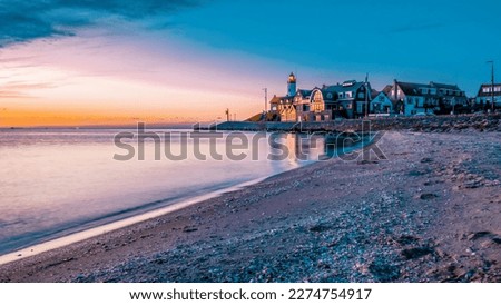sunset at the lighthouse and harbor of Urk Holland. Fishing village Urk. Beautiful sunset during the evening in Urk Flevoland Netherlands 