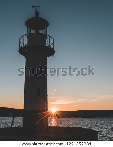 sunset and a lighttower 