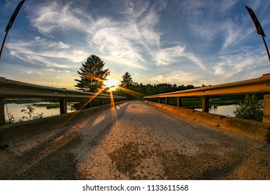 sunset looking down a bridge 