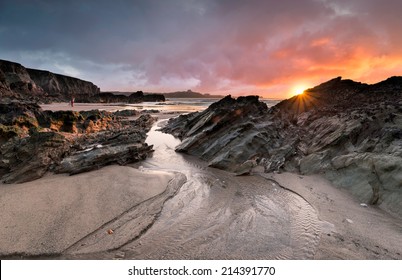 Sunset at Lusty Glaze beach at Newquay in Cornwall - Shutterstock ID 214391770