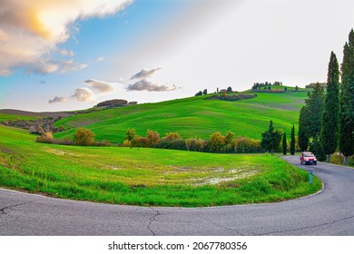  Sunset. The Magnificent Italian Province Of Tuscany. Fields And Hills Are Covered With Light Fog. Evening Twilight. The Winding Road To The Farm On Top Of A Hill 