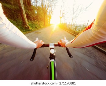 Sunset, Man On Road Bike. POV, Original Point Of View. 