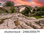 Sunset at the medieval bridge of Cangas de Onís, located in Asturias, Spain