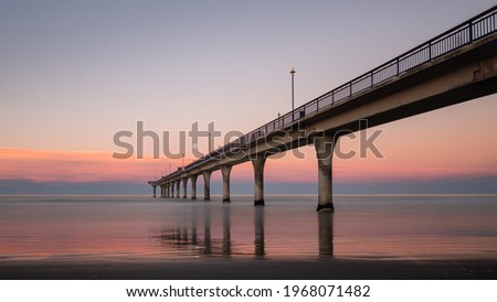 Sunset and moon rise at the same time at New Brighton Pier, Christchurch, New Zealand