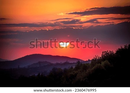 Sunset with a mountain view and dramatic sky and clouds