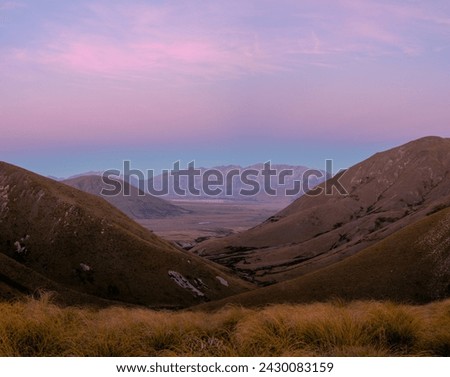 Sunset in mountains with viev to a valley below, Canterbury, new Zealand