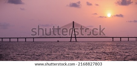 sunset near mumbai worli bandra sea link bridge and small boat in ocean