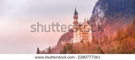 Sunset Neuschwanstein Castle in Germany located in Fussen, Bavaria, banner panorama