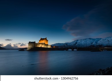 Sunset/ Night Photo Of Eilean Donan Castle With Snow On The Mountains In Scotland, December 2017