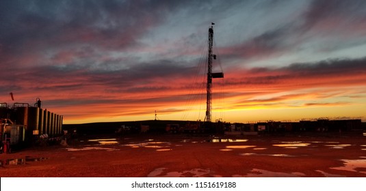 sunset in north dakota oil field.
