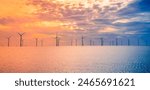 Sunset Offshore Wind Turbine in a Wind farm under construction of England coast, UK