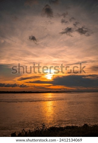 Sunset on the Amazon River in Colombia, vibrant skies and the art of nature