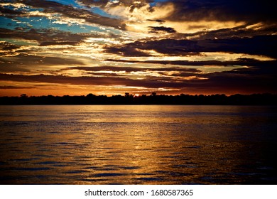 Sunset On The Amazon River With Rainforest In Iquitos In Peru 
