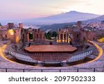 Sunset on the ancient roman-greek amphitheater with the Giardini Naxos bay in the back in Taormina, Sicily, Italy