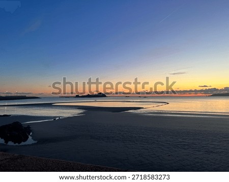 Sunset on the bathing pools across St Aubins Bay 