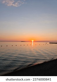Sunset on the beach, seashore, calm water, sunset sun and coastline - Shutterstock ID 2376000841