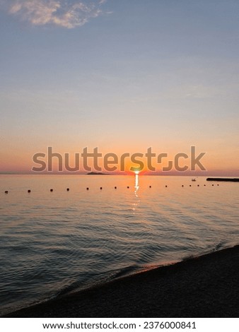 Sunset on the beach, seashore, calm water, sunset sun and coastline