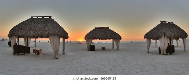 Sunset On The Beach Under A Tiki Hut