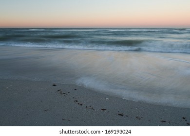 Sunset on a beach, with waves blurred by long exposure.  Casey Key, FL, USA. - Shutterstock ID 169193024