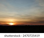 Sunset on blue sky. Blue sky with some clouds. blue sky clouds, summer skies, cloudy blue sky background. Aerial sunset view. Evening skies with dramatic clouds. View over the clouds.