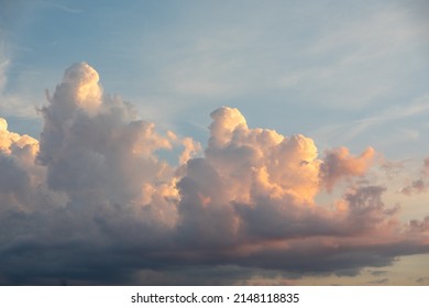 Sunset on blue sky. Blue sky with some clouds. blue sky clouds, summer skies, cloudy blue sky background. Aerial sunset view.  Evening skies with dramatic clouds. View over the clouds. - Powered by Shutterstock