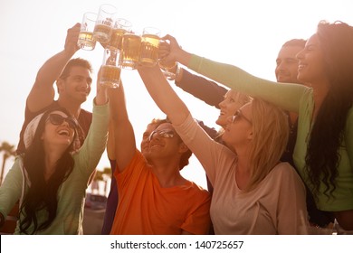 Sunset On The Boardwalk With Friends At The Beach Cheering With Beer At A Bistro