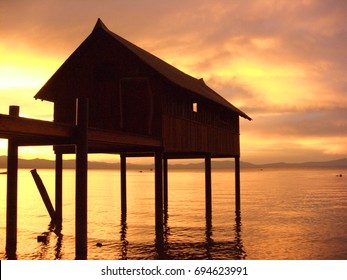 Sunset On A Boat Wood House And Pier On The South Shore Of Lake Tahoe, CA