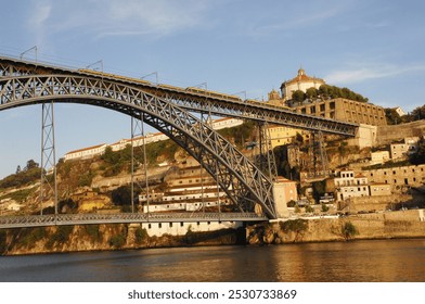Sunset on the D Luis bridge over the Douro River in the city of Porto in Portugal, designed by Gustave Eiffel, which connects the city with Vila Nova da Gaia. Horizontal photo
