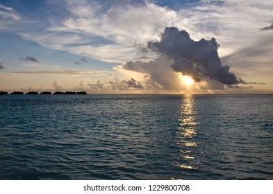 Sunset on Indian ocean with warm palette through the fluffy clouds