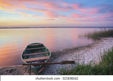 Sunset On The Lake, Fishing Boat On The Shore